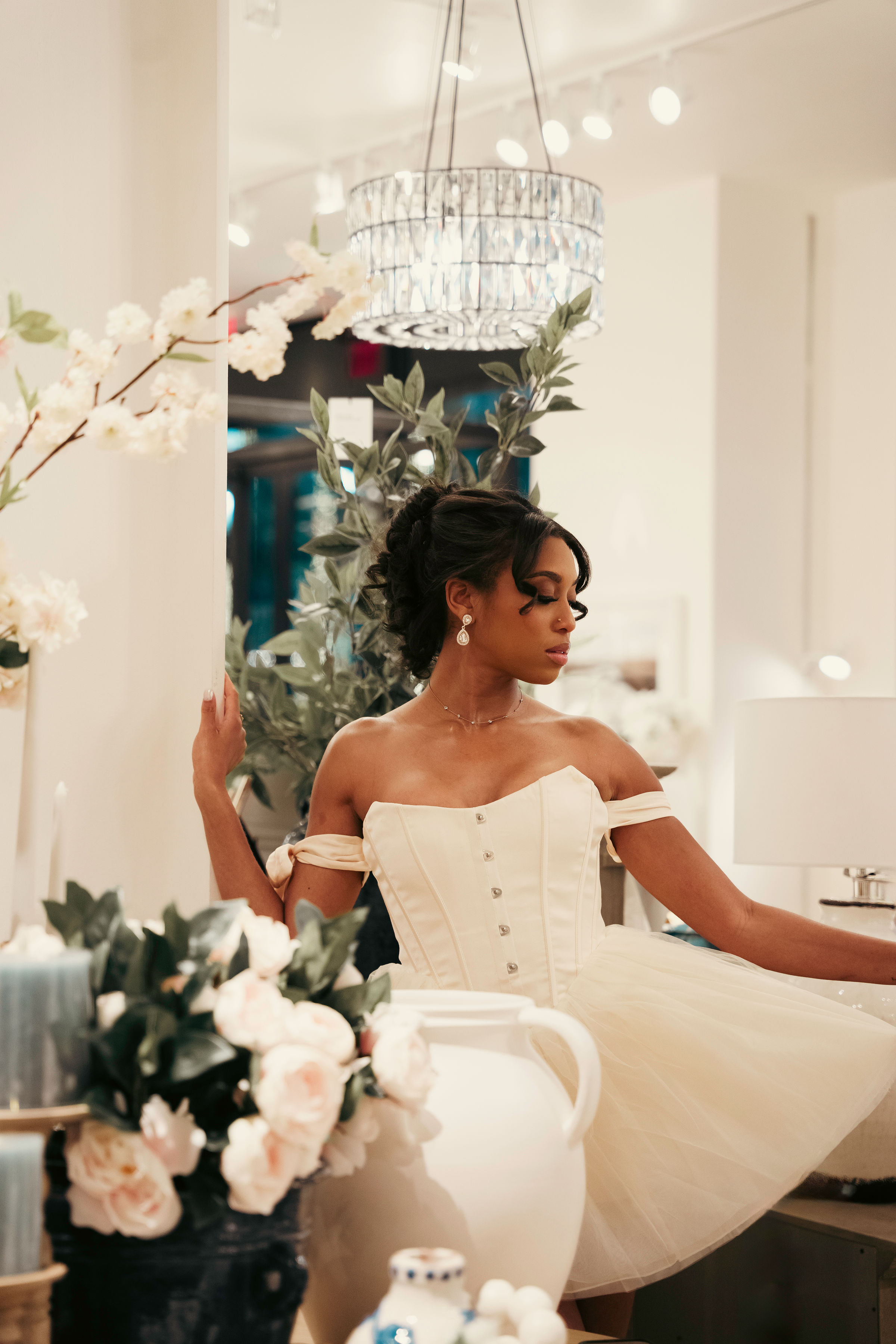 Iyana Admasu in a ballerina dress, flowers in the foreground