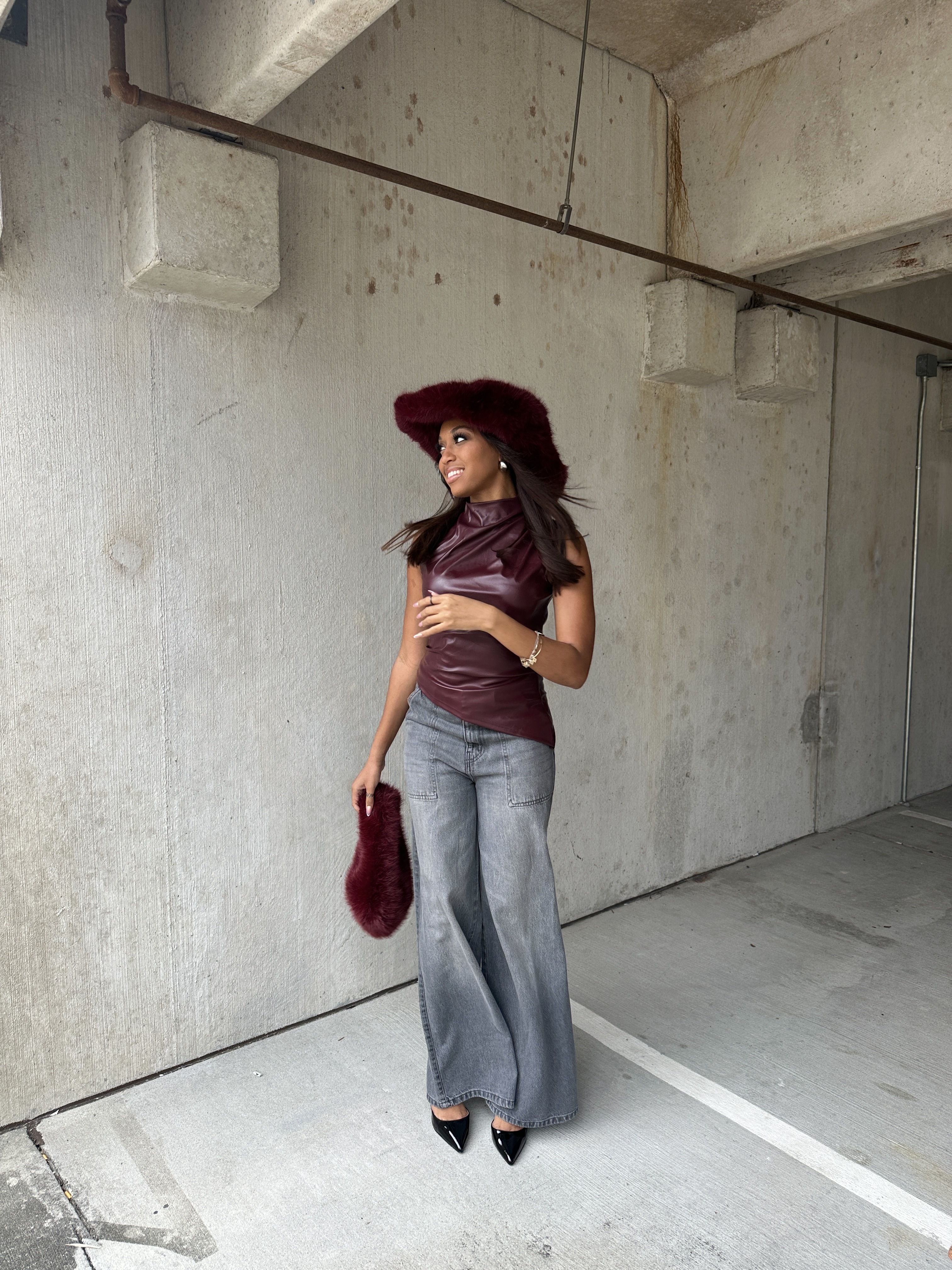 Iyana Admasu smiling in a leather and fur look